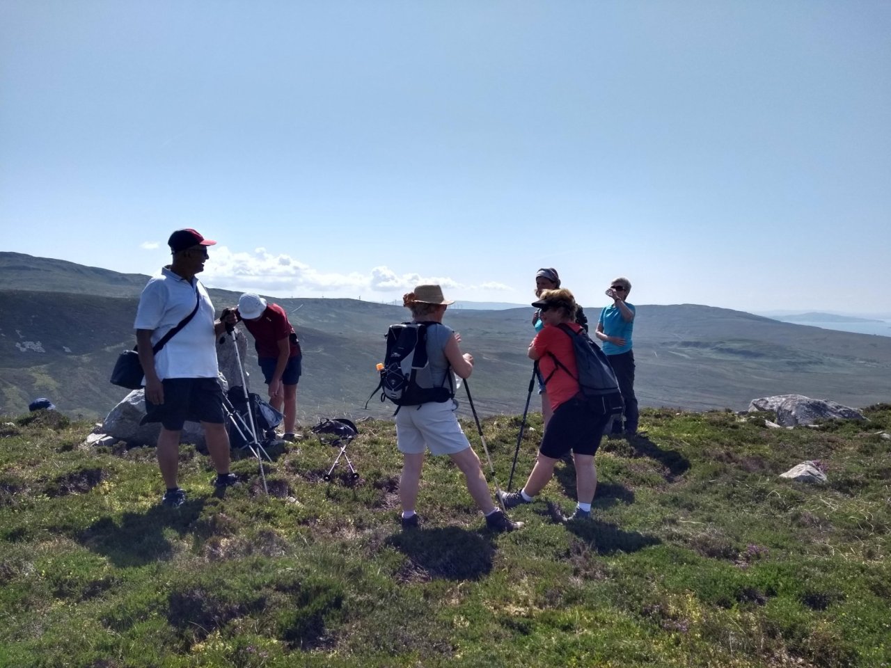 people walking on top of hill